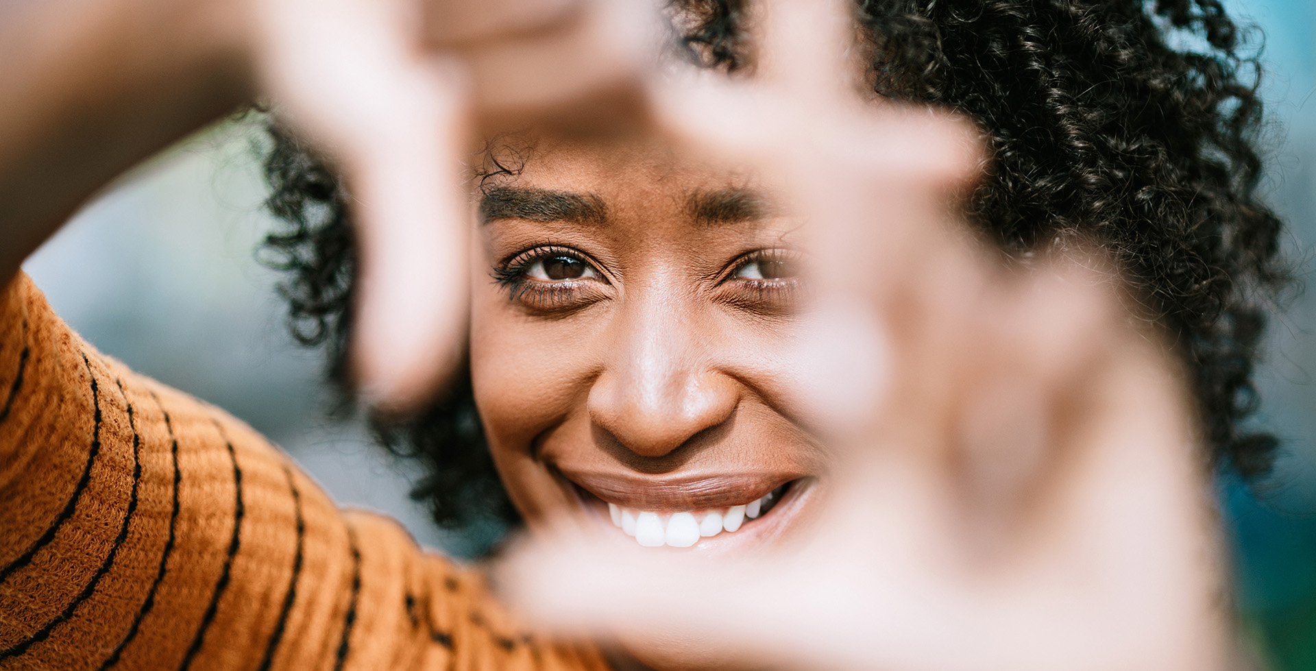 A woman smiling with her hands up