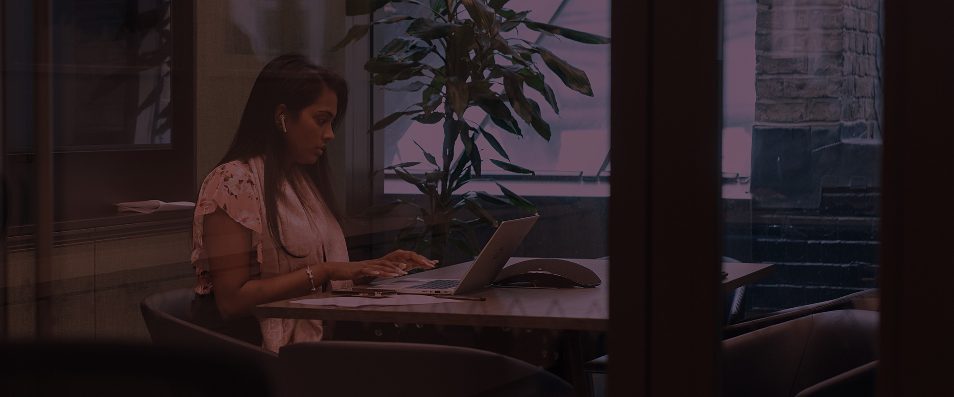 Woman sat at desk looking at laptop