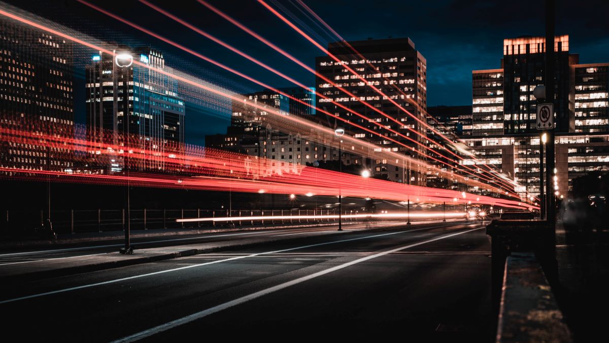 Lights streaming through a city at night - energy transition.